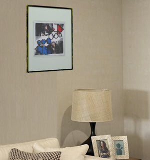 Mockup einer dezent belichteten Wohnzimmrecke mit auflockerdem Webslm BlauRot im Passepartout und Bilderrahmen