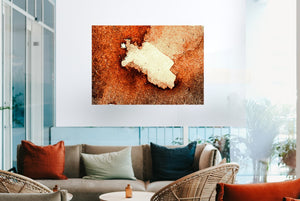 Fine-Art Poster „Blatt 31.1“ aus dem „Blauen Skizzenbuch“ von johann franki über einem Sofa in einem stylischen Cafe – das  Motiv im Querformat zeigt ein abstraktes Objektin krassen Ambertönen. 
