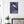 c63c2121-8ad4-4d49-9d5d-d38c83fcf1cfFine-Art Poster „Blatt 43.2“ aus dem „Blauen Skizzenbuch“ von johann franki in einer Diele mit weißgekalkter Wand und Topfpflanze – das Motiv im Hochformat zeigt eine zeichnungshafte Darstellung unbestimmter Natur auf freier blauer Fläche.
